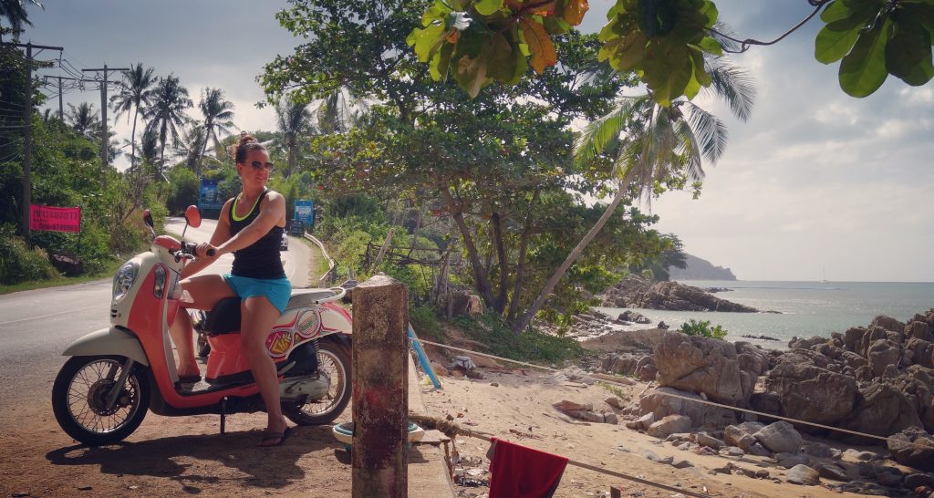 woman on moped near tropical beach
