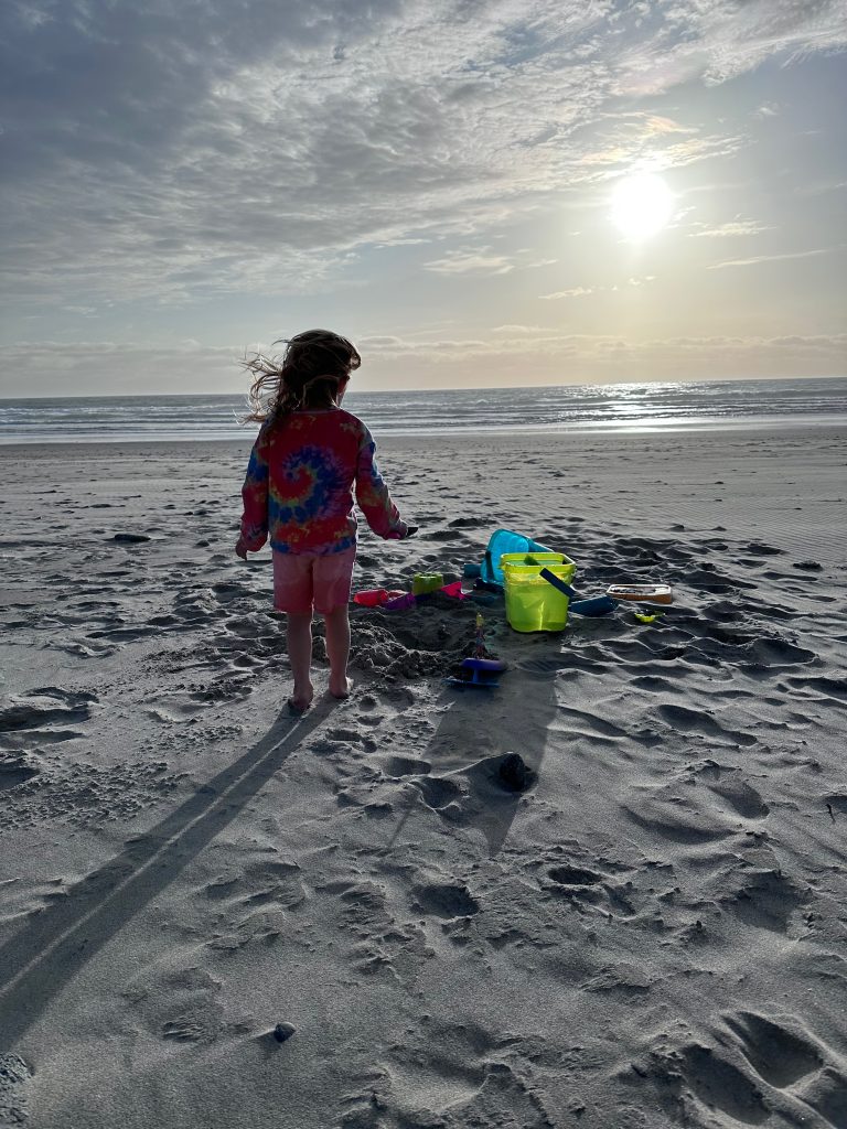 Toddler playing in the sand at the beach