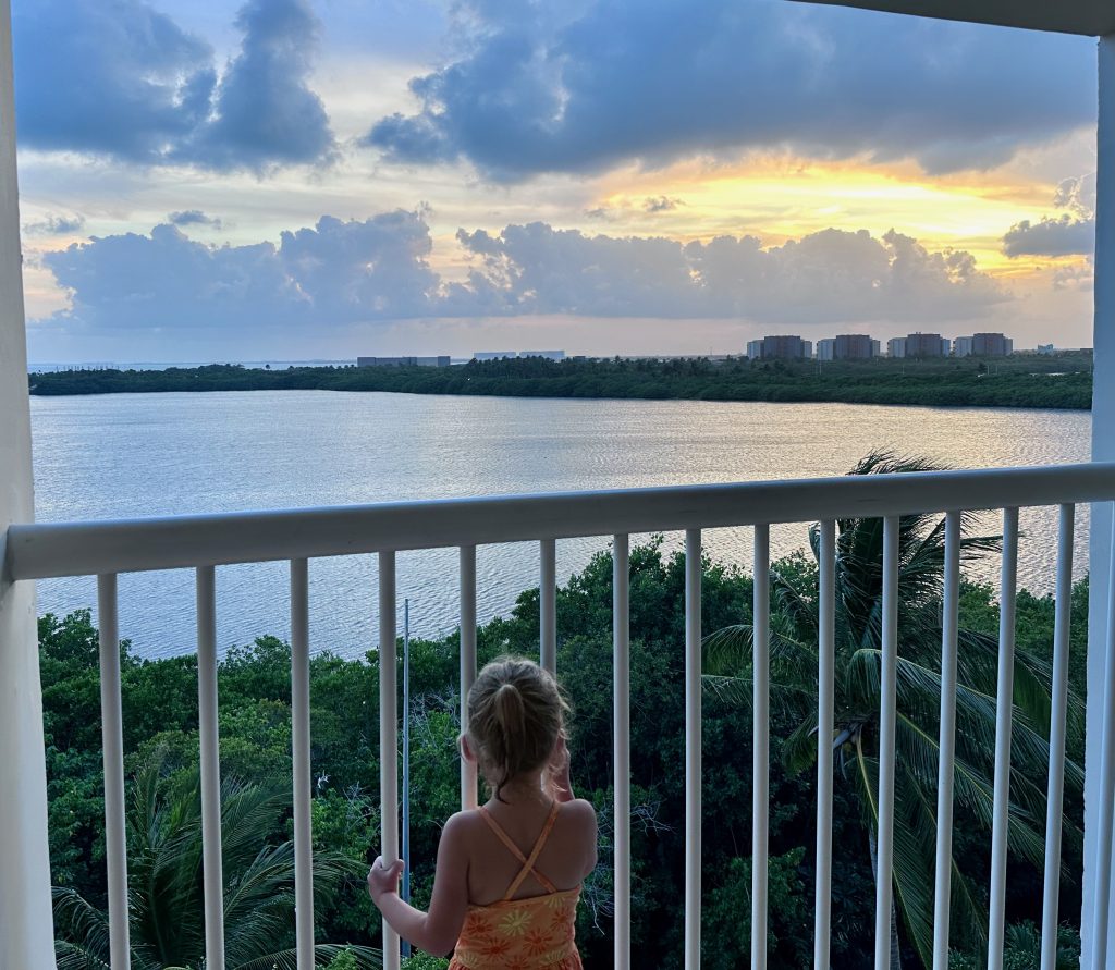 Child watching sunset in Cancun
